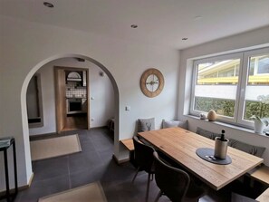 A modern kitchen with an archway leading to a dining area.