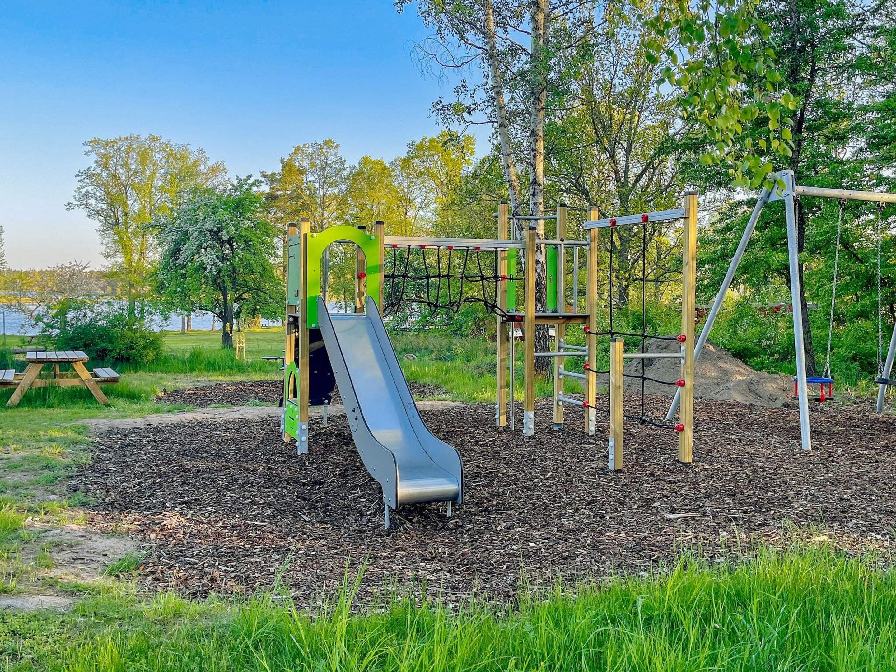 A playground with a slide and climbing structures.