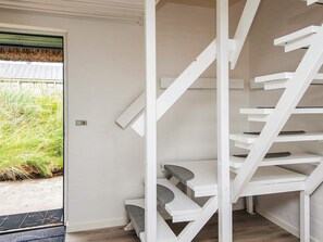 A white spiral staircase with multiple steps leading to a landing. - 7 Person Holiday Home in Ulfborg (Ulfborg)
