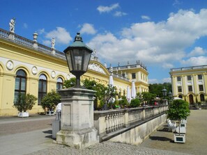 A historic building with classical architecture, a paved courtyard, and outdoor seating areas. - Engemann Modern Retreat (Kassel)
