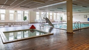 An indoor swimming pool with a slide, a red cone, and a ladder. - 4 Person Holiday Home in Fano (Fano)