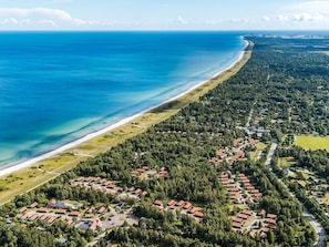 An aerial view of a coastal residential area with houses and a beach. - 6 Person Holiday Park Home in Vaeggerlose (Vaeggerlose)