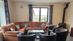 A living room with a brown sofa, two black armchairs, a small table, and a fireplace. - Well-equipped Holiday Home With Terrace (Stavelot)
