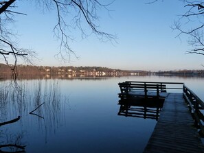 A calm lake with a wooden dock extending into the water. - Holt Stuuv Comfortable Holiday Residence (Ratzeburg)