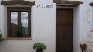 A rustic building with a wooden door and window, labeled "LA CURIOSA". - Holiday Home in Laroya Near Centre (Laroya)
