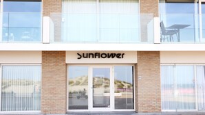 A building with a sign reading "Sunflower" above the entrance. - Apartment in Nieuwpoort With Garden (Nieuwpoort)