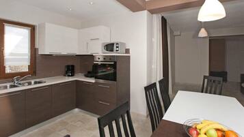 Villa | Private kitchen | Oven, electric kettle, toaster