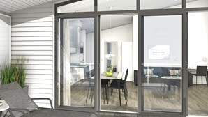 A modern interior with a dining area, a kitchen, and a living space. - Holiday Home in Wendtorf (Wendtorf)