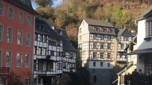 A traditional European town with half-timbered houses, a stone bridge, and a river. - Mechthild and Hans-jurgen Geschwind (Schleiden)
