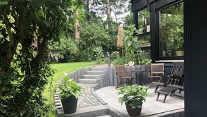 A curved stone staircase leading to a patio with outdoor seating. - Mechthild and Hans-jurgen Geschwind (Schleiden)