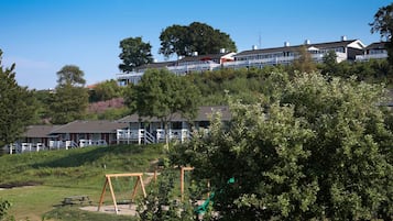 A residential area with houses, a playground, and picnic tables.