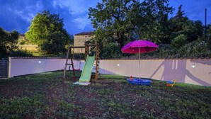 A backyard with a slide, a swing set, and a play area. - Villa G With Pool in Barban (Barban)