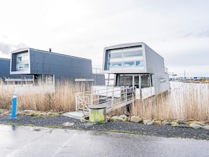 A modern building with a metal exterior, a covered walkway, and a view of the surrounding area. - 5 Star Holiday Home in Hemmet (Hemmet)
