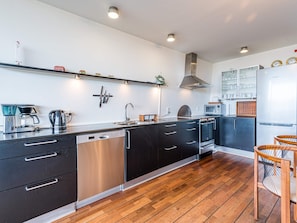A modern kitchen with a dishwasher, oven, and microwave. - 5 Star Holiday Home in Hemmet (Hemmet)