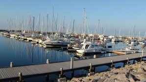 A marina with numerous sailboats docked at wooden piers. - Lighthouse View Modern Retreat (Bastorf)