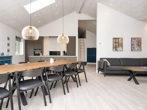 A modern interior with a dining area, kitchen, and living space. - 5 Star Holiday Home in Ansager (Ansager)
