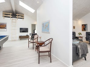 A modern living room with a pool table, a dining area with chairs, a sofa, and a television. - 5 Star Holiday Home in Ansager (Ansager)