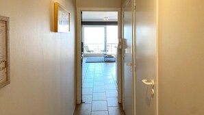 A hallway leading to a balcony with a view. - Apartment in Nieuwpoort Near the Beach (Nieuwpoort)