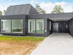 A modern building with large windows and a concrete entrance.