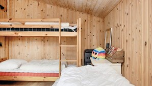 A wooden bunk bed room with a ladder, a desk with a mirror, and a colorful plush toy. - 5 Person Holiday Home in Asaa (Asaa)