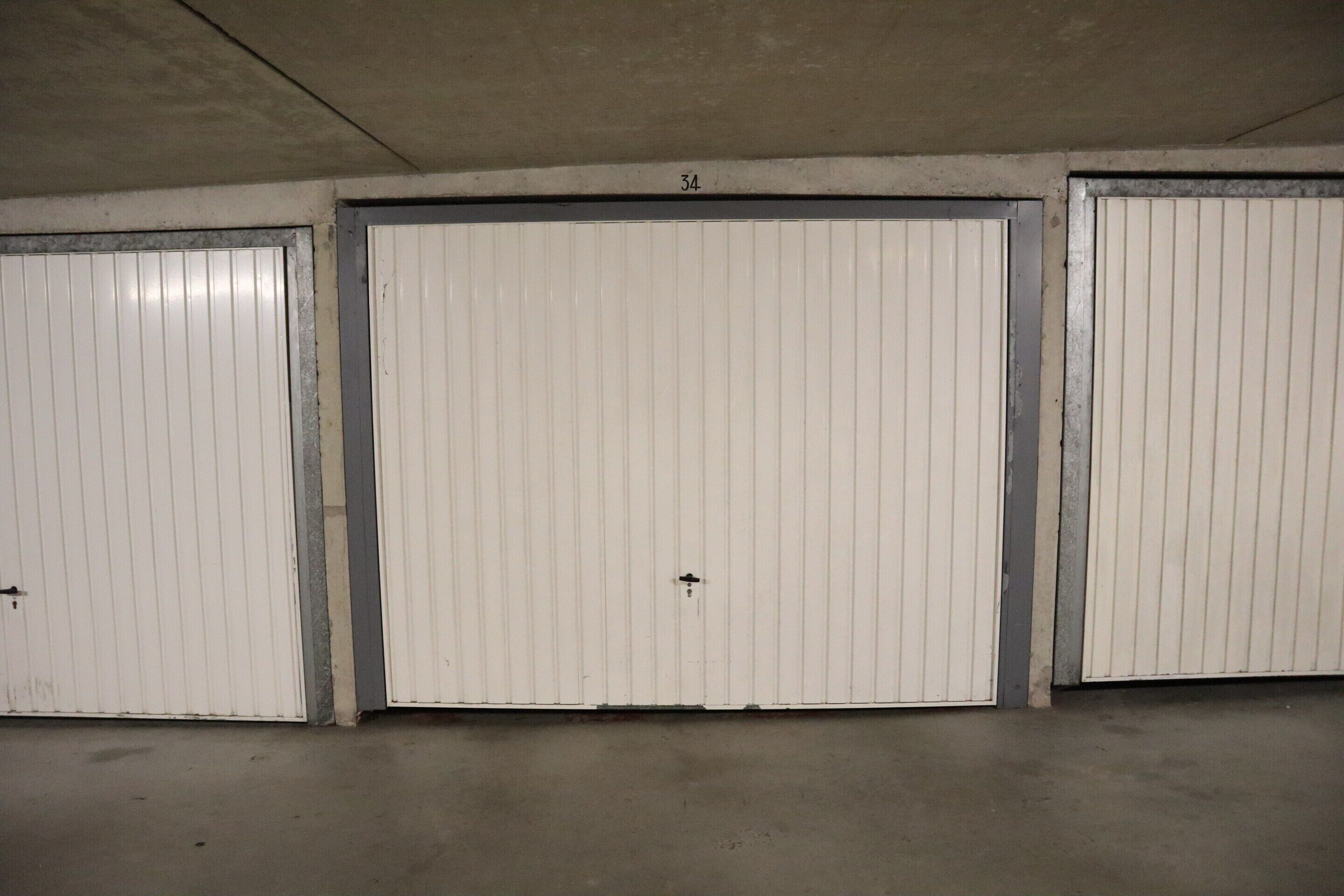 Three closed white doors with a number '34' above the middle door.