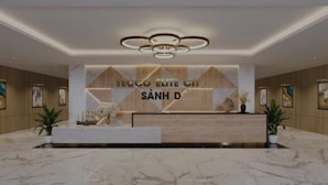 A modern reception desk with a wooden finish and a sign that reads "TECCO ELITE CITY SÂNH D". - Happy Home (Quan Trieu)