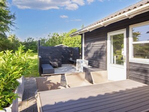 An outdoor deck with seating and a built-in air conditioning unit. - 4 Person Holiday Home in Ebeltoft (Ebeltoft)