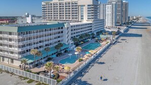 A hotel with multiple floors, a swimming pool, and a beach view. - Oceanfront Balcony | 1BR  | Pools |Hot Tubs (Daytona Beach)