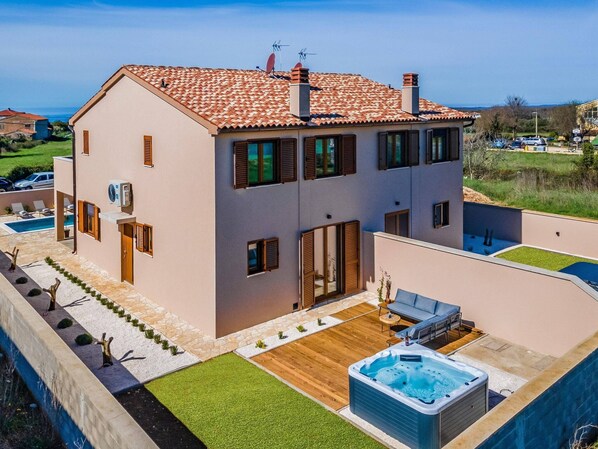 A two-story house with a swimming pool, hot tub, and a patio area. - Family Villa With Pool, Wellness (Vodnjan)