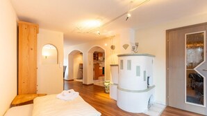 A hotel room with a bed, wooden flooring, a bathroom with a shower, and a view of the city. - Nice Apartment in Langenfeld With Sauna (Laengenfeld)