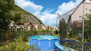 A residential area with a swimming pool, trampoline, and houses with sloped roofs. - Sauna Retreat in Sulz (Sulz am Neckar)