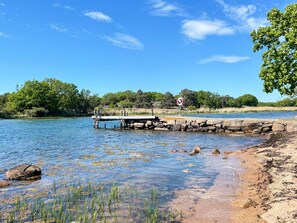 A clear river with a dock, a no-entry sign, and surrounding greenery. - 4 Star Holiday Home in Torhamn (Torhamn)
