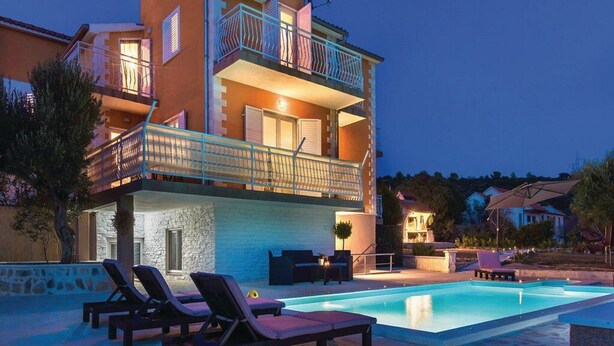 A two-story building with a swimming pool, lounge chairs, and outdoor furniture. - Apartment Niko - Two Bedroom Apartment With Swimming Pool (Sibenik)