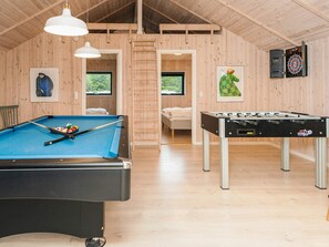 A room with a pool table, a foosball table, a dartboard, and a bed with a view of greenery. - 5 Star Holiday Home in Fano (Fano)