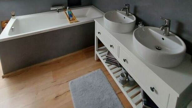 A modern bathroom with a large bathtub, two sinks, and a mirror. - Holiday House on Bornfeld (Leimen)