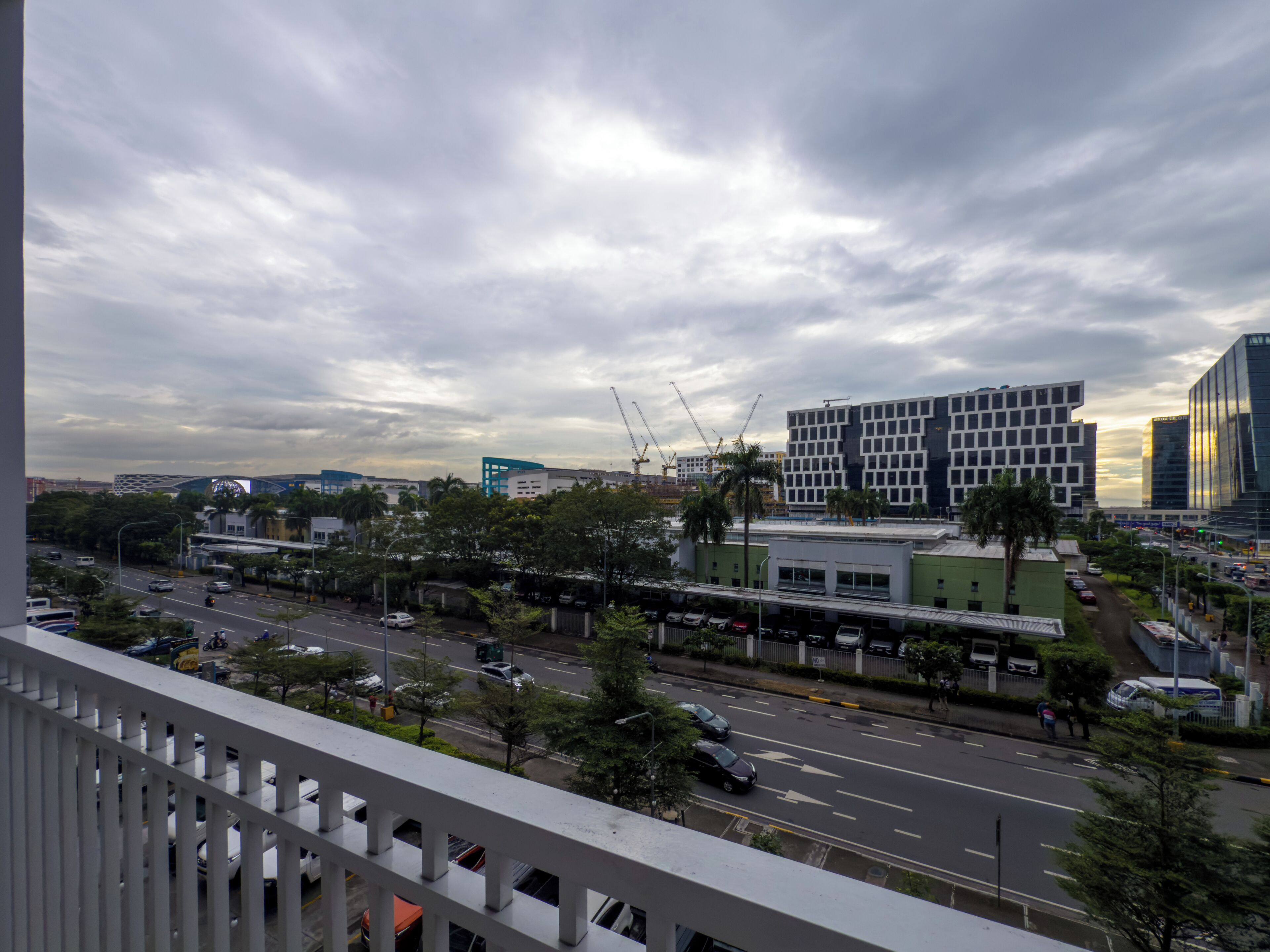 A cityscape with modern buildings, a busy street, and a clear sky.