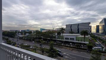 A cityscape with modern buildings, a busy street, and a clear sky.