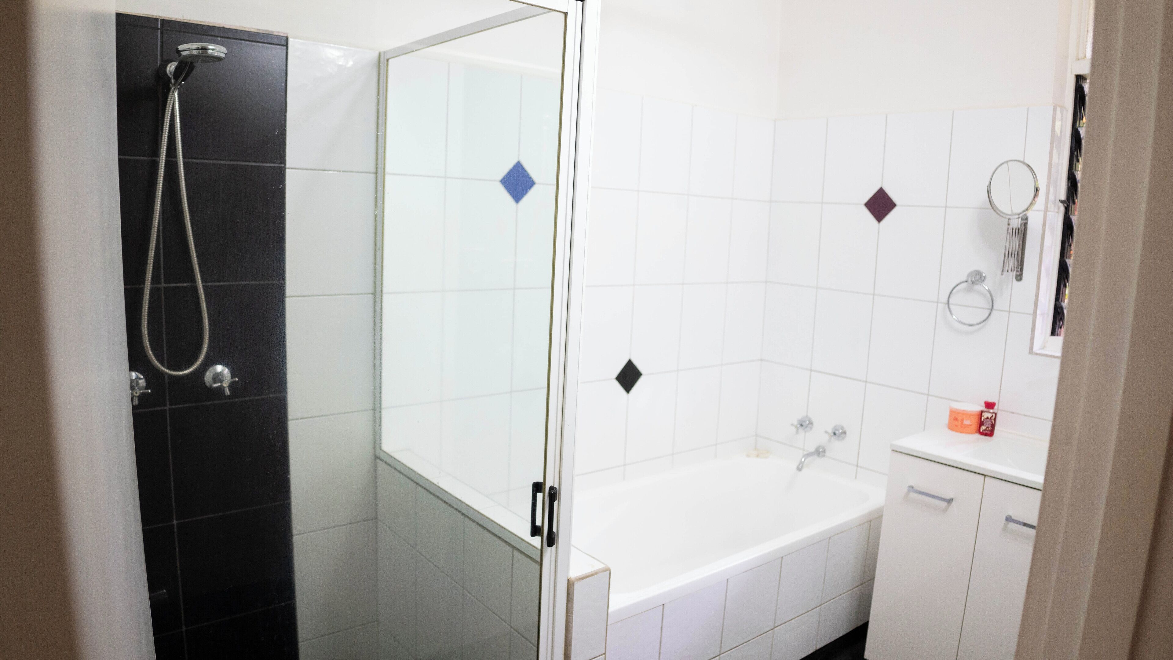 A bathroom with a shower, a bathtub, and a toilet.