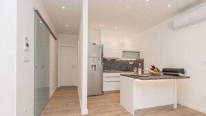 A modern kitchen with a central island, built-in appliances, and a minimalist design.