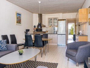A compact living space with a dining area, kitchen, and seating area.