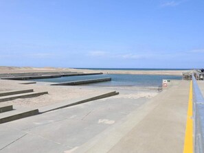 A coastal area with concrete steps leading to the beach, a clear sky, and a no-entry sign. - 2 Person Holiday Home in Snedsted (Snedsted)