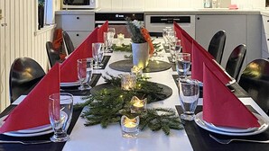 A dining table set for a meal with a white tablecloth, red napkins, and candles. - 10 Person Holiday Home in Syssleback-by Traum (Sysslebäck)