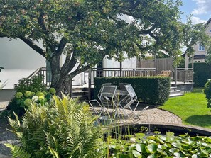 Relax amidst lush greenery and serene surroundings, complete with a tranquil pond and deck.