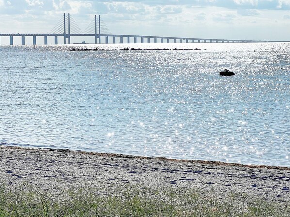 A coastal view with a bridge in the background.