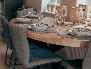 A dining table set with plates, bowls, cutlery, and glasses. - "T Holy Pad Comfortable Holiday Residence (Egmond aan Zee)