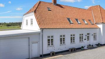 Standalone building with a red-tiled roof and multiple windows.
