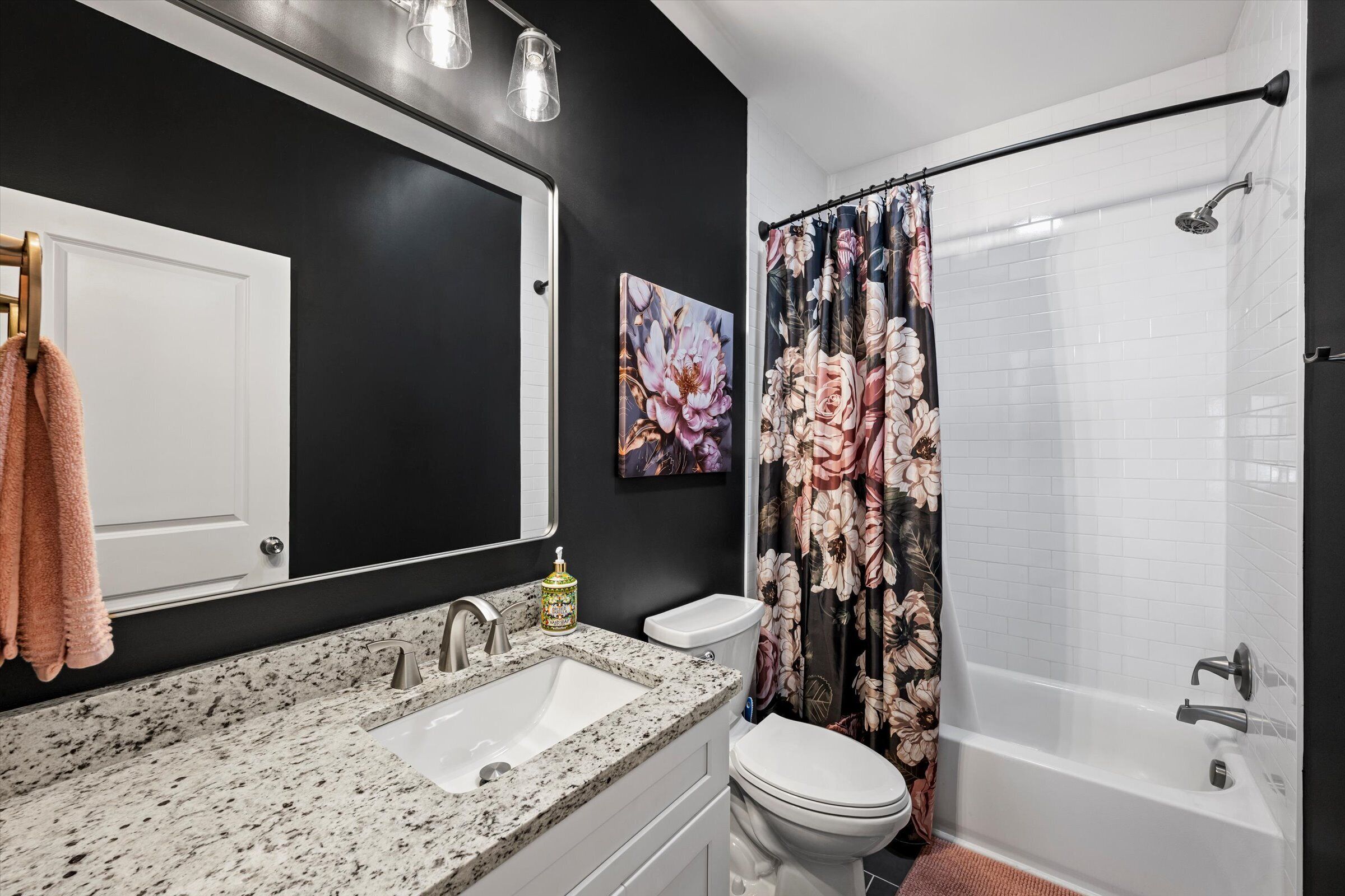 A bathroom with a sink, toilet, and bathtub.