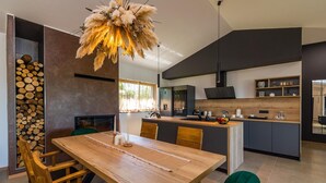 Une cuisine moderne dotée d’un îlot central, d’une table à manger en bois et de chaises.
