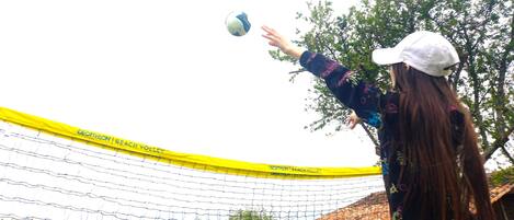 A volleyball net with yellow borders and the text "DECATHLON BEACH VOLLEY" on it.