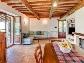 Cozy living room with a fireplace, bookshelf, and sliding glass door to an outdoor area.